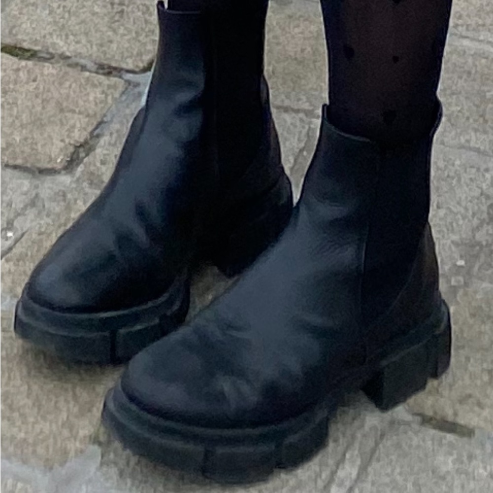 Black Chelsea boots with silver stripe on the back